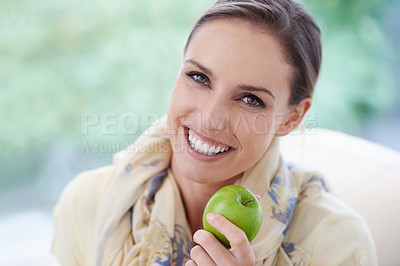 Buy stock photo Portrait, apartment or happy woman with apple for healthy or balanced diet with nutrition or vitamins. Face, chair or vegan person eating fresh fruit, food or fibre for organic wellness in lounge