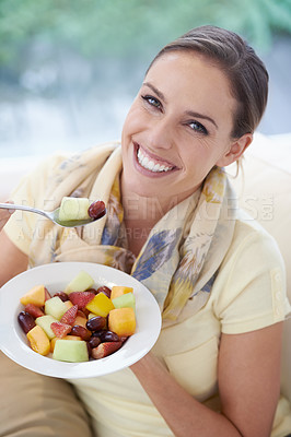 Buy stock photo Healthy food, happy woman in portrait and fruit in salad for diet, organic meal and relax on sofa with smile for weight loss. Vegan, gut health and wellness, eating for nutrition with vitamins