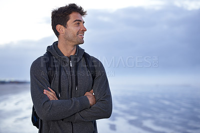 Buy stock photo Thinking, beach and man with arms crossed, travel and backpack with holiday, idea or getaway trip. Person, seaside or traveller with nature or wellness with water, explore or smile with summer break