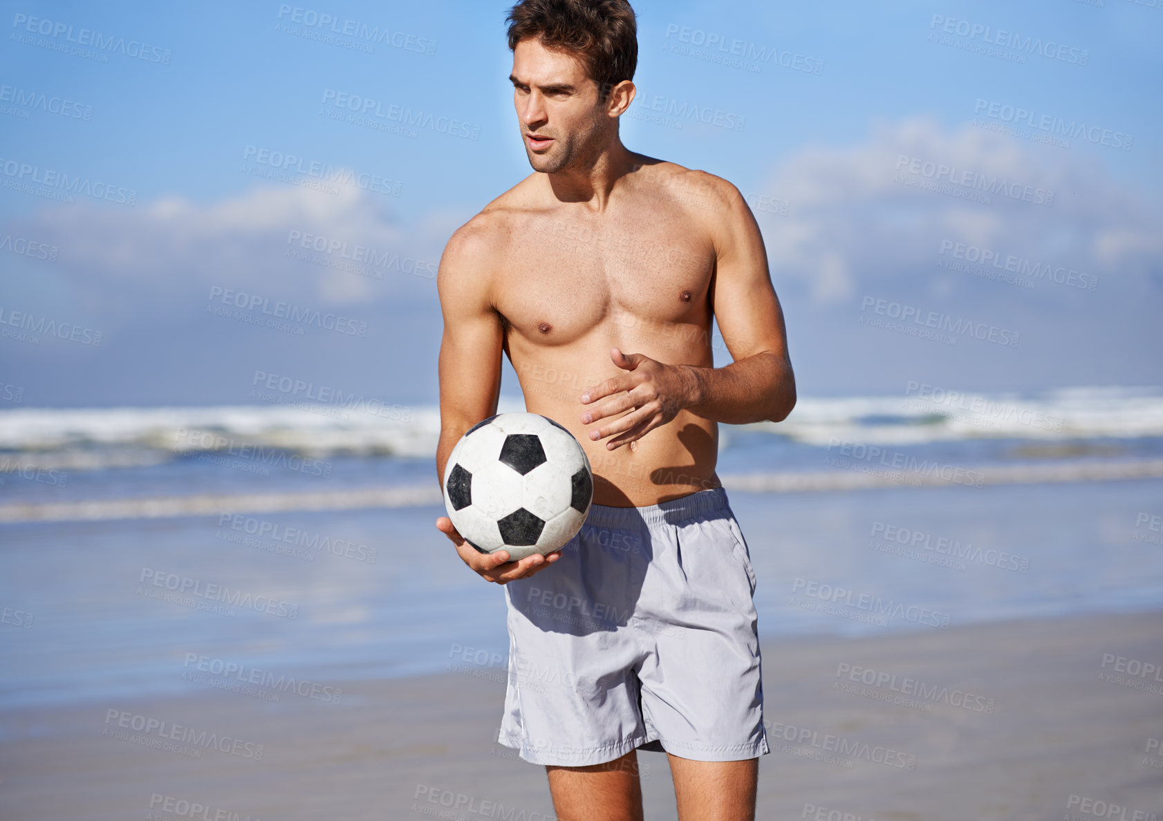 Buy stock photo Man, beach and soccer ball for game, sports or exercise in outdoor hobby for training or practice. Young male person or football player on ocean coast for match or cardio workout by the seaside