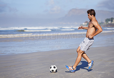 Buy stock photo Man, beach and playing soccer for game, sports or exercise in outdoor hobby, training or practice. Young male person or football player with ball on ocean coast for match or cardio workout by seaside