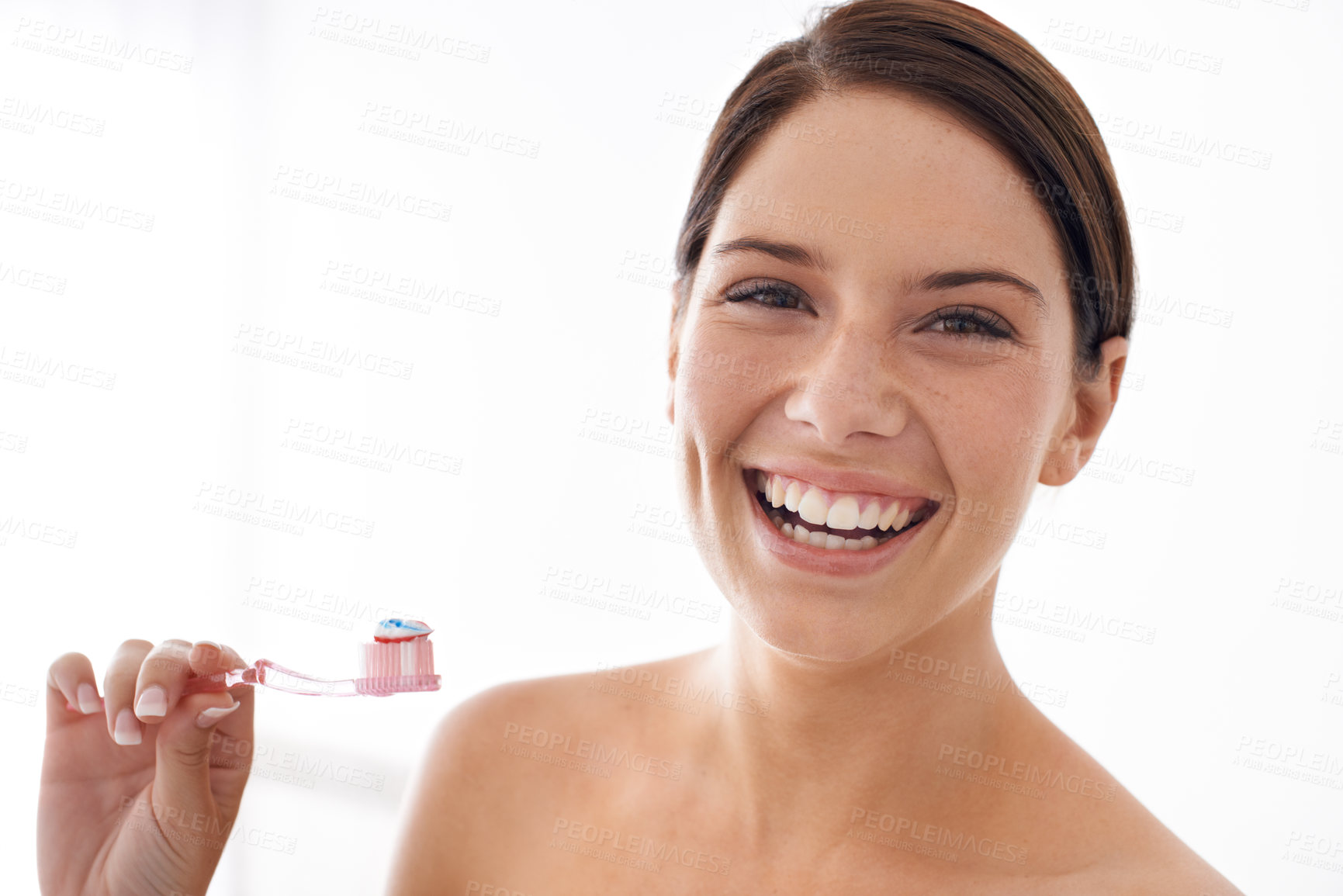 Buy stock photo A gorgeous young brunette brushing her teeth in the morning