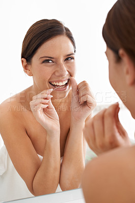 Buy stock photo Portrait of an attractive young woman flossing her teeth