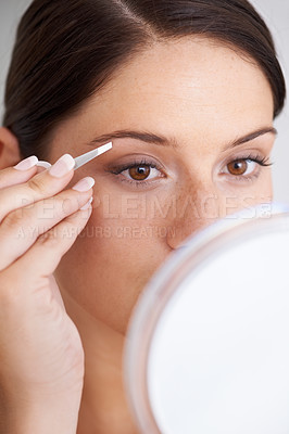 Buy stock photo Plucking, eyebrow and woman with tweezers for beauty, self care and mirror in bathroom. Makeup, routine and girl with hair removal, tools and facial grooming or cleaning for skincare and cosmetics