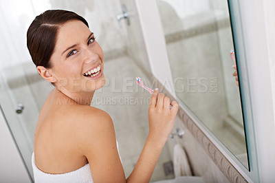 Buy stock photo A gorgeous young brunette brushing her teeth in the morning