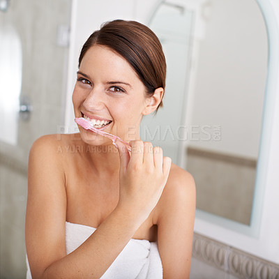 Buy stock photo A gorgeous young brunette brushing her teeth in the morning