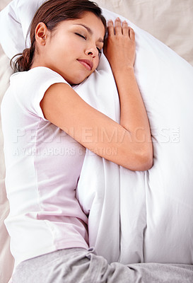 Buy stock photo Sleeping, pillow and woman relax in bedroom for comfort, cozy nap and rest with eyes closed in home apartment. Top view, fatigue and Mexican person sleep on mattress bed with calm, peace and wellness