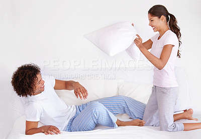 Buy stock photo Man, woman and pillow fight for funny game on morning holiday for love connection, game or vacation. Happy partnership, cushion and pajamas or laughing in home for play couple comedy, joy or smile