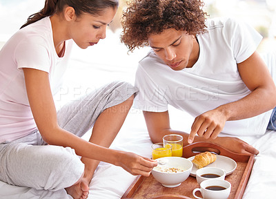 Buy stock photo Couple, love and eating breakfast together for bonding, healthy meal and relaxing in bedroom. People, food and nutrition on diet at home, hunger and romance on anniversary for marriage milestone