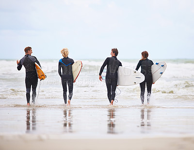 Buy stock photo Young surfers excited about hitting the awesome waves