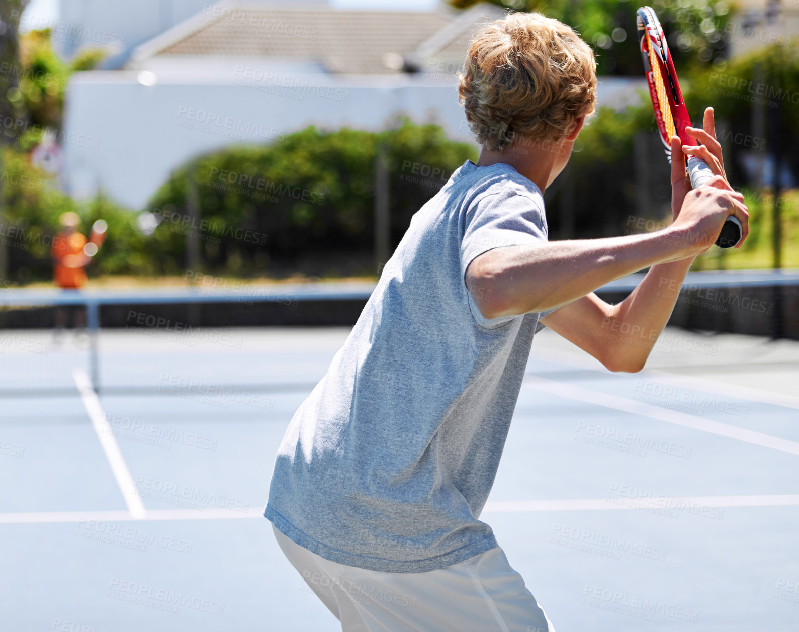 Buy stock photo Rearview shot of a young man playing tennis