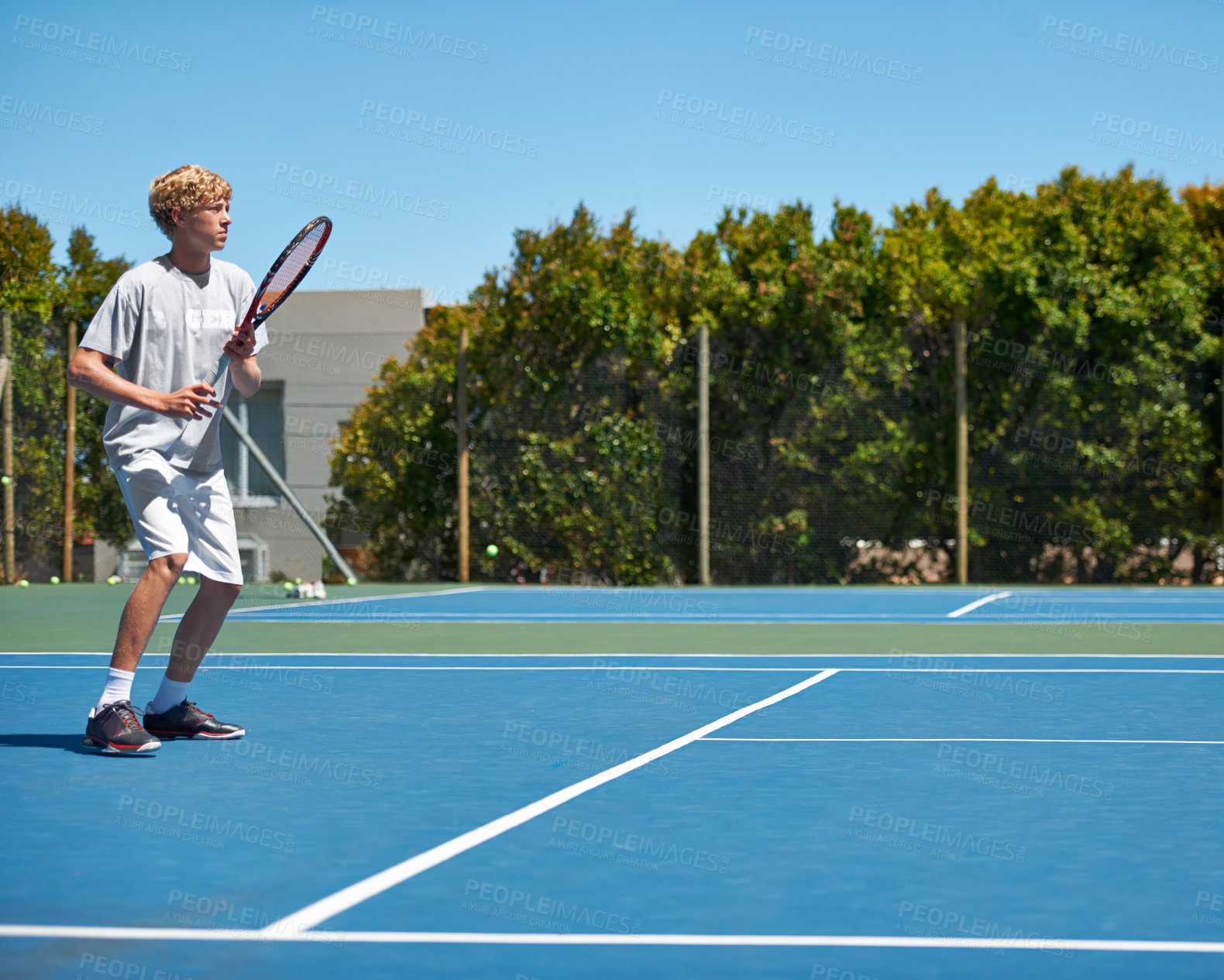 Buy stock photo Tennis, sports and teenager with energy, training and performance with competition or workout. Person, player or athlete with racket or court with wellness, activity or game with sunshine or hobby