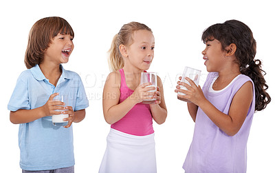 Buy stock photo Happy, children and milk in glasses with nutrition, health and wellness in white background of studio. Calcium, drink and kids smile and laugh with dairy, protein and benefits in diet for energy