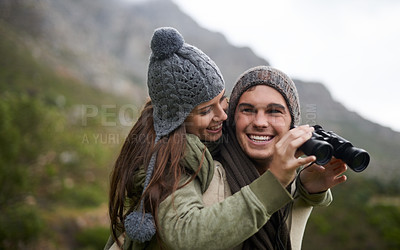 Buy stock photo A young couple taking in all the scenary while enjoying a mountain hike