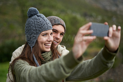 Buy stock photo Couple, selfie and smile while hiking in nature, smartphone and capture moment in outdoors. People, happy and picture for memory and exploring wilderness, trekking and photograph for social media