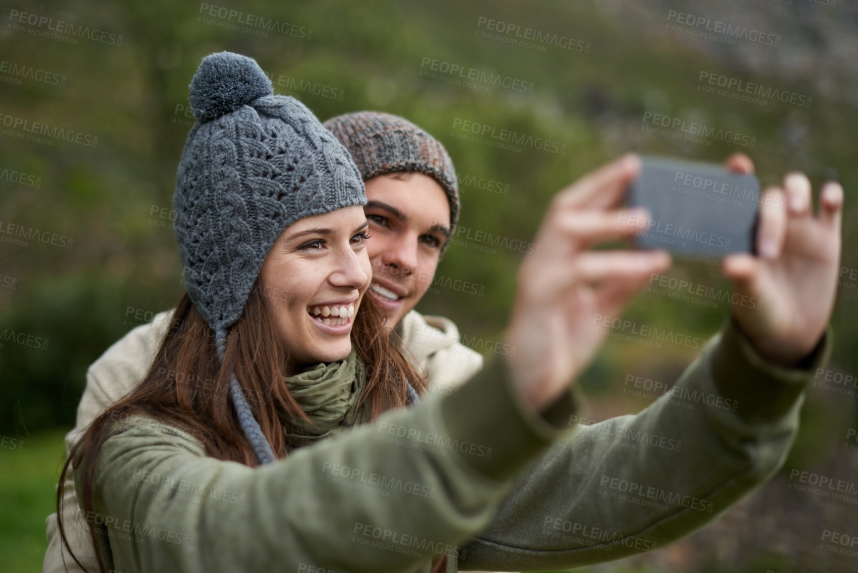 Buy stock photo Couple, selfie and smile while hiking in nature, smartphone and capture moment in outdoors. People, happy and picture for memory and exploring wilderness, trekking and photograph for social media