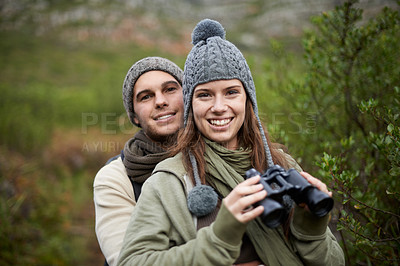 Buy stock photo Hiking portrait, binocular and couple smile for nature getaway, weekend break and camping retreat in eco forest. Sustainable woods, love and people bond on travel adventure, trekking or bird watching