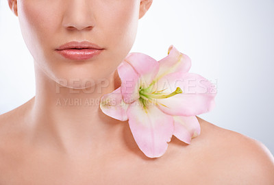 Buy stock photo Closeup, woman and skincare with flowers, beauty and wellness on a white studio background. Half, person and model with natural cosmetics and grooming with treatment, shine and glow with dermatology