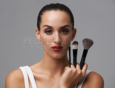 Buy stock photo Woman, brush for makeup and beauty in portrait, cosmetic tools with cosmetology and skin on grey background. Red lipstick, confidence and face of model in studio, foundation or powder with equipment