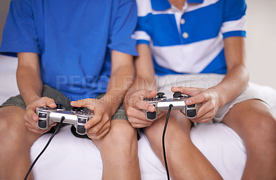 Buy stock photo Video game, hands and closeup of children with controllers on bed for entertainment together. Gamers, console and zoom of boy kid friends playing online for fun or hobby sitting in bedroom of home.