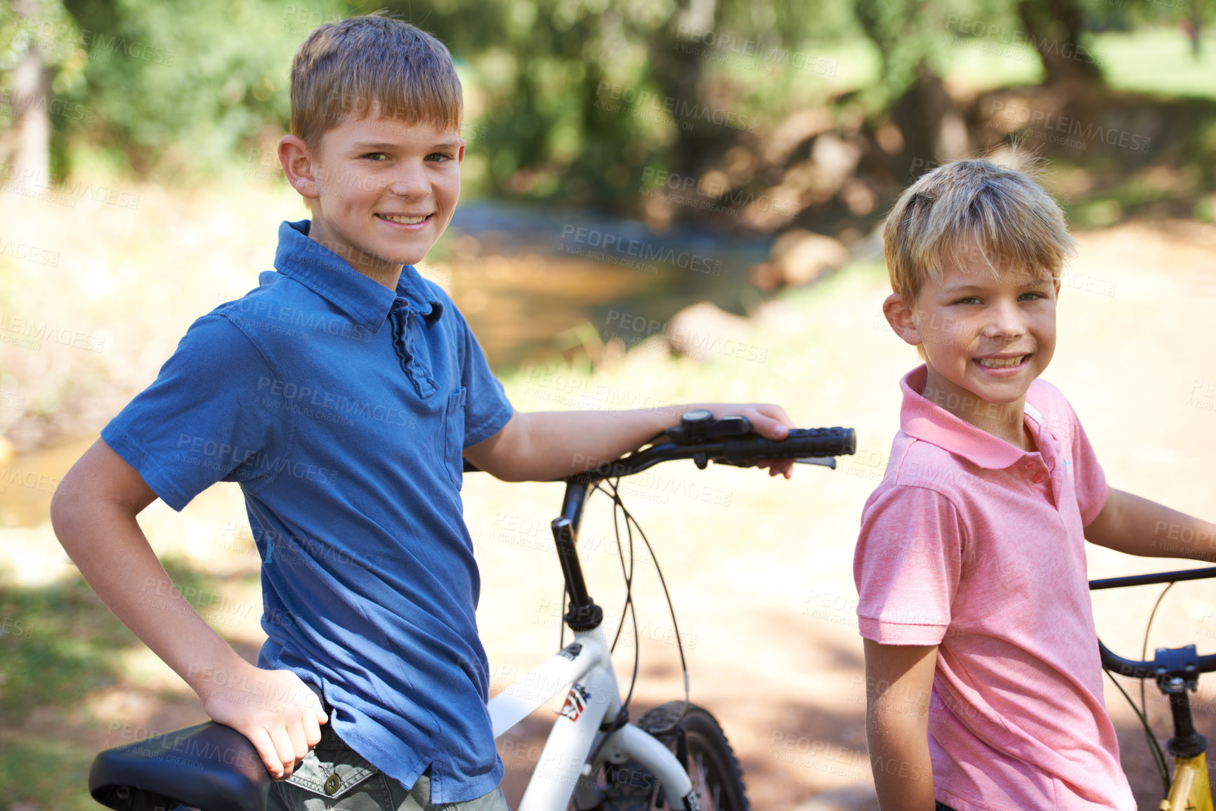 Buy stock photo Nature, bicycles and portrait of boy children riding in outdoor field, park or forest for exercise. Happy, cycling and confident young kids on bikes for cardio, hobby or training in a garden.