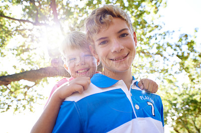 Buy stock photo Piggy back, portrait and boys in a forest, summer and vacation with happiness or bonding together. Fresh air, face or young people in a park or relax with a game and sunshine with lens flare or smile