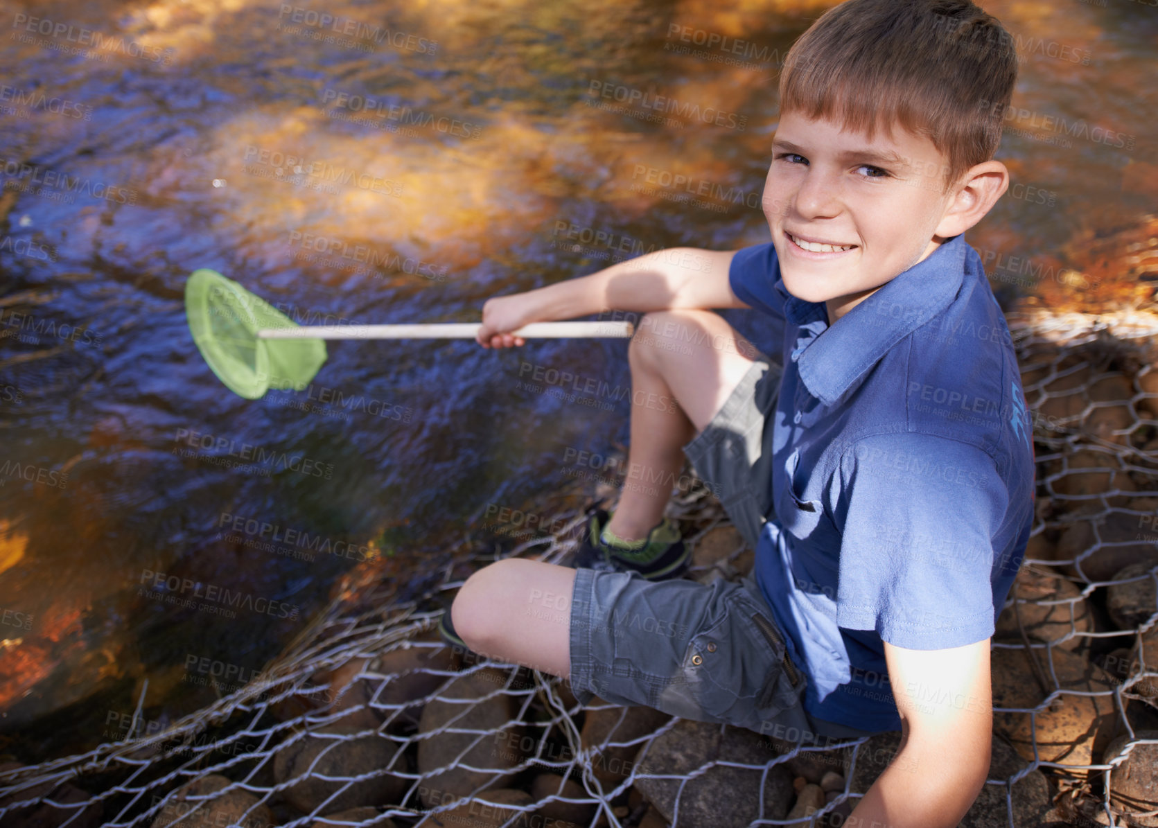 Buy stock photo Child, portrait and fishing net at river in nature for outdoor adventure or youth development, summer or countryside. Kid, boy and equipment for catch hobby in lake for learning, practice or skill