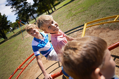 Buy stock photo Children, playground and carousel or park fun together as friends for speed, excitement or fast. Kids, boys and brothers on field for playing game in sunshine for bonding connection, outdoor or joy