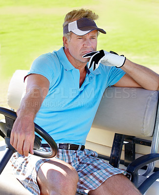 Buy stock photo A mature man sitting in a golf cart looking thoughtfully into the distance