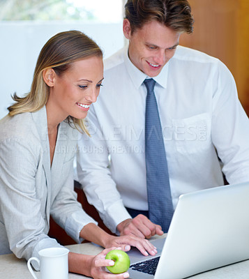 Buy stock photo Happy couple, laptop and apple for breakfast, healthy meal or morning nutrition in kitchen at home. Man and woman on computer in digital with green organic fruit and coffee for diet or wellness