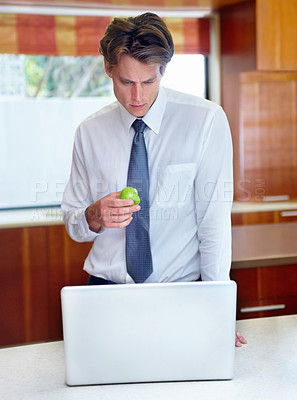 Buy stock photo Laptop, apple and business man in kitchen for morning routine, remote working and healthy breakfast. Professional, worker and person on computer for website, research and internet in home with fruit
