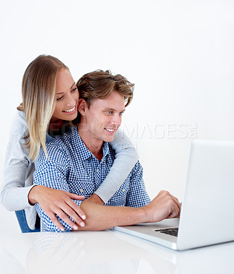 Buy stock photo Couple, laptop and hug with email, online information and social network scroll with a smile. Marriage, computer and tech with web research, support and love on the internet with white background