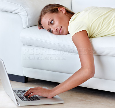 Buy stock photo Woman, couch and laptop for movie in home, scroll and relax with reading, ideas and thinking. Girl, person and lying on sofa, choice or click in living room, floor and computer to watch film in house