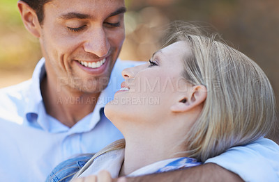 Buy stock photo Happy couple, closeup and hug in nature for embrace, love or support in relax for outdoor bonding. Face of young woman and man with smile for affection, comfort or romance in forest or woods together