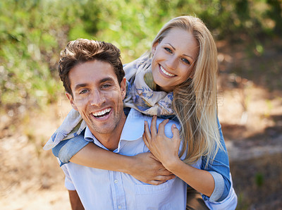 Buy stock photo A loving young couple standing together outdoors