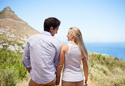 Buy stock photo Happy couple, holding hands and mountain for hiking, journey or outdoor adventure together. Rear view or back of man and woman in love, commitment or support in trust, holiday or weekend in Cape Town