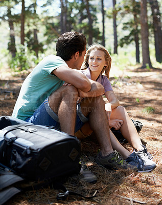 Buy stock photo Couple, hiking break and travel in forest for outdoor fitness, adventure and wellness journey or health in nature. Happy man and woman relax on ground or talking of trekking destination with backpack