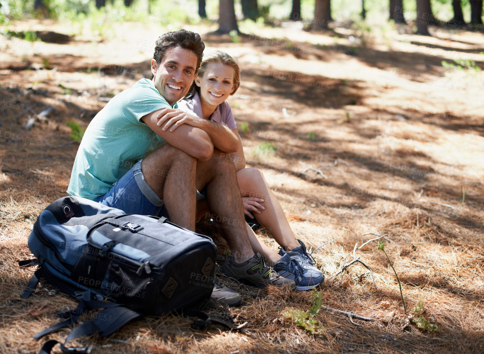 Buy stock photo Couple, hiking break and portrait in nature for outdoor travel, adventure and wellness journey by forest. Happy man and woman relax on ground with backpack for trekking destination, health or fitness
