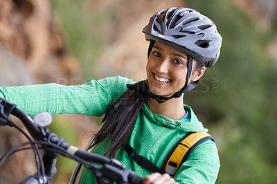 Buy stock photo A lovely young woman mountain biking in a scenic setting