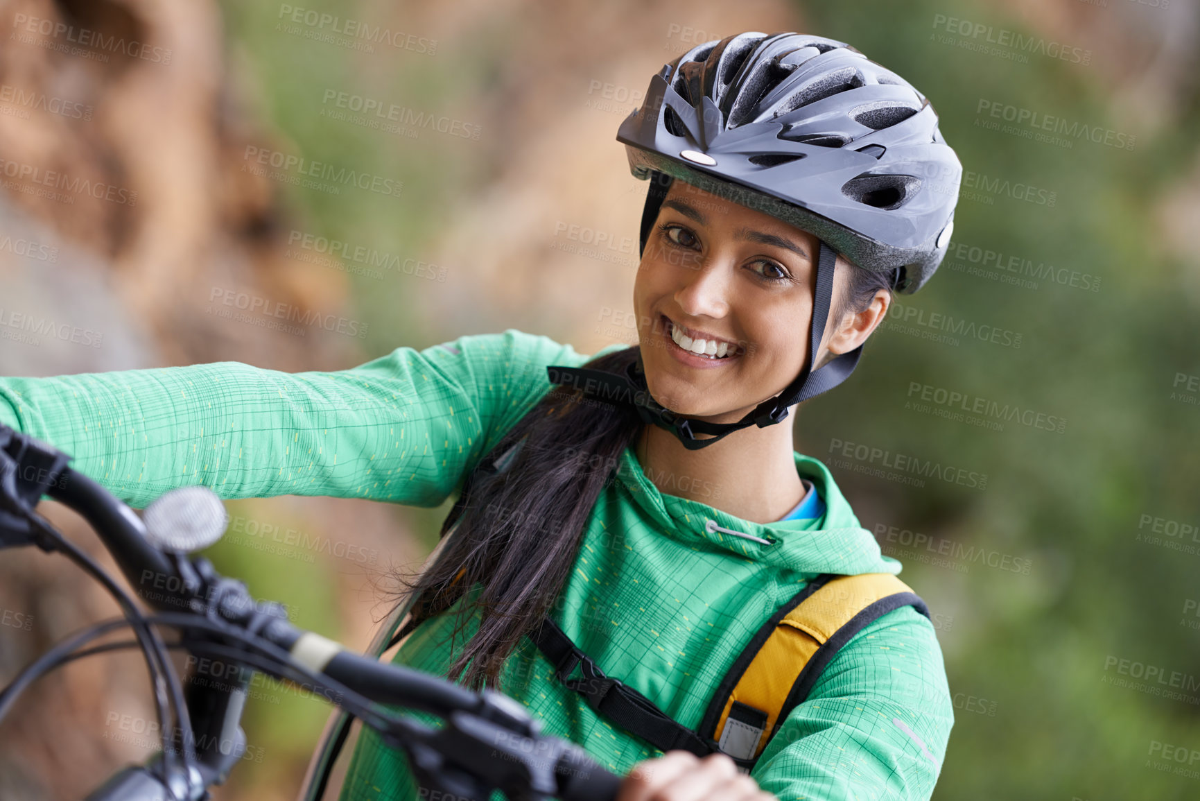 Buy stock photo A lovely young woman mountain biking in a scenic setting