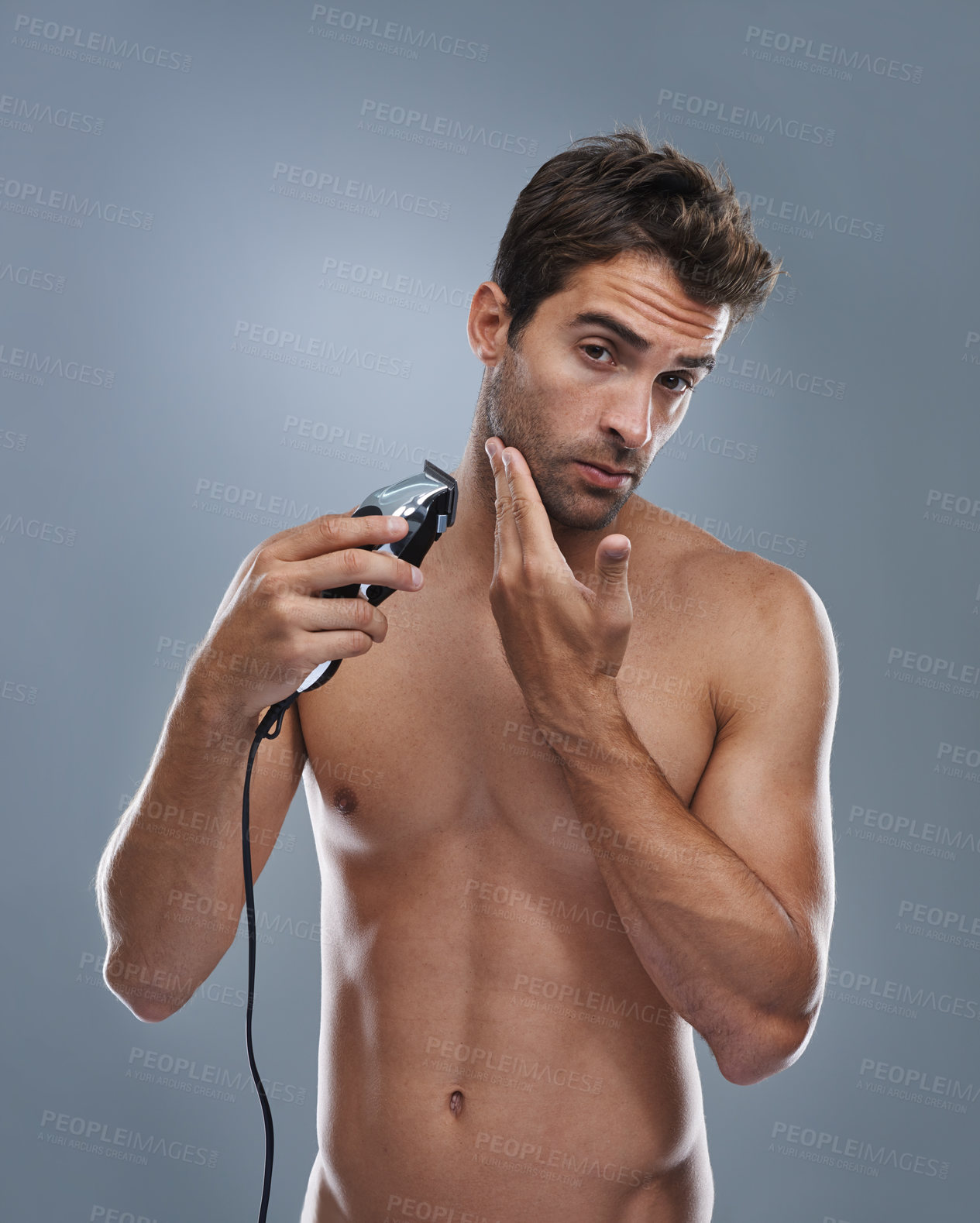 Buy stock photo Man, electric razor and studio portrait for beard grooming, skincare and wellness by grey background. Person, model and shaving with hygiene, facial hair removal and product for cosmetic change