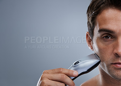 Buy stock photo Man, electric razor and studio with space for grooming, skincare and wellness in mockup by grey background. Person, model and beard with hygiene, facial hair removal and promotion for cosmetic change