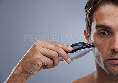 Buy stock photo Man, electric razor and closeup studio portrait for grooming, skincare or wellness by grey background. Person, model and shaving beard with hygiene, facial hair removal or product for cosmetic change