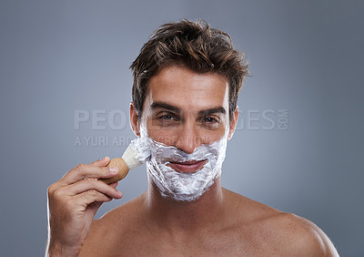 Buy stock photo Man, portrait and shaving cream with brush studio application for healthy skin, hygiene or confidence. Male person, face and beard or fresh hair removal as maintenance care, grey background or mockup