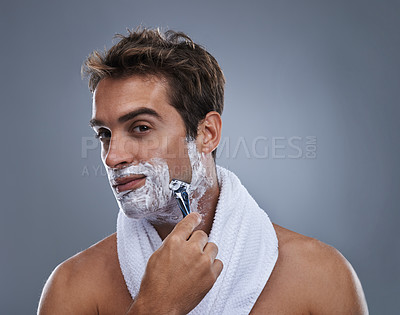 Buy stock photo Man, razor and shaving cream in studio portrait for grooming, skincare and wellness by grey background. Person, model and beard with hygiene, facial hair removal and foam product for cosmetic change