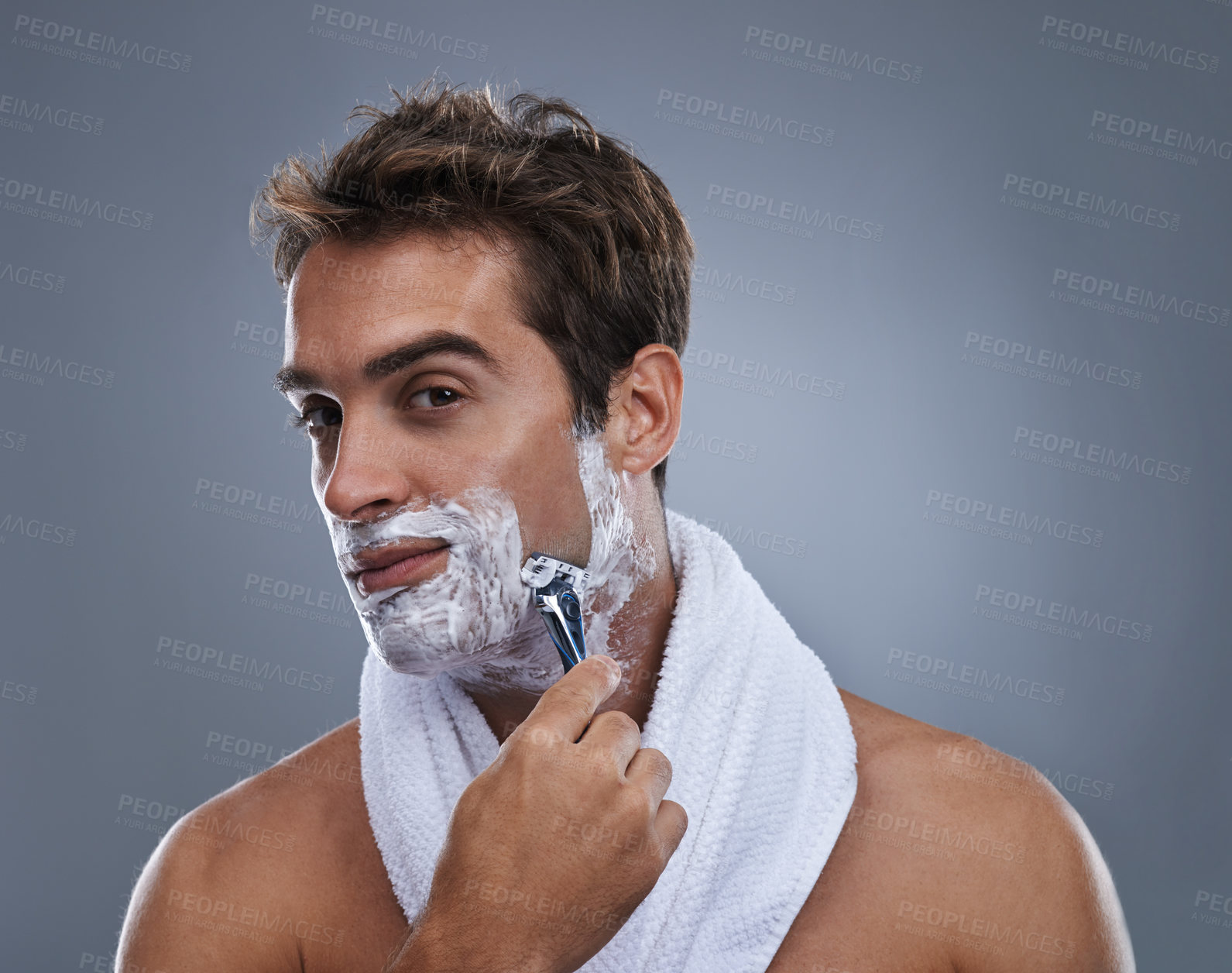 Buy stock photo Man, razor and shaving cream in studio portrait for grooming, skincare and wellness by grey background. Person, model and beard with hygiene, facial hair removal and foam product for cosmetic change