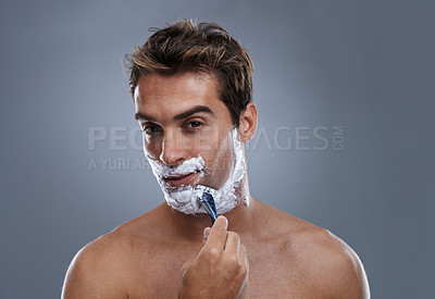 Buy stock photo Man, razor and face with shaving in studio portrait for grooming, skin and wellness by grey background. Person, model and blade with cream, facial hair removal and foam product for hygiene with beard