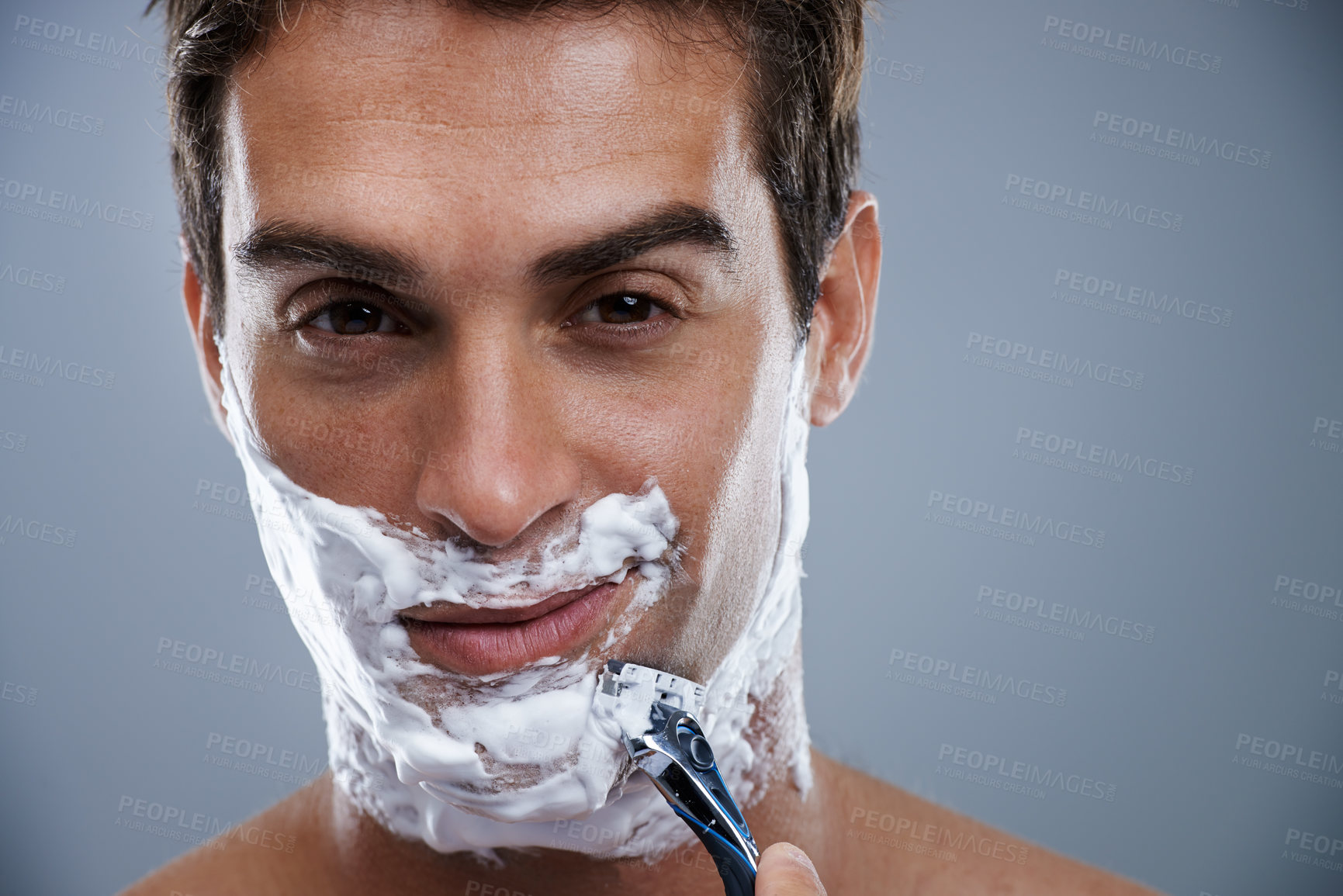 Buy stock photo Man, razor and shaving in studio closeup for grooming, skincare and beard in portrait by grey background. Person, model and self care with cream, facial hair removal and product for cosmetic change
