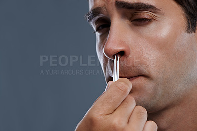 Buy stock photo Man, nose and hair with tweezers for cleaning on grey background for self care, wellness or hygiene. Male person, face and grooming for cosmetic beauty for healthy routine, studio or mockup space