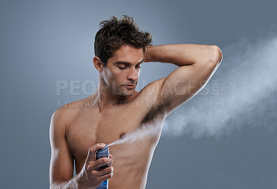 Buy stock photo Man, deodorant and spray for healthy odor in studio or product application for clean smell, hygiene or grey background. Male person, topless and confidence or armpit wellness, care or mockup space
